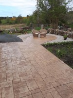 Shaped patio area in pattern imprinted concrete,  with gravel surrounds, by GM Hard Landscapes, County Donegal, Ireland